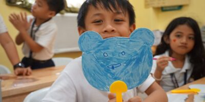 Student showing his picture at drawing class